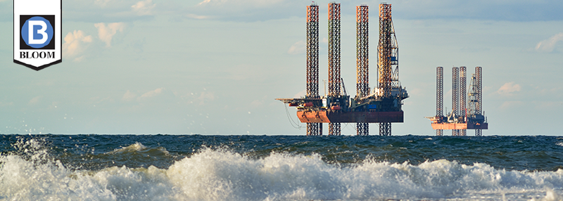 Picture of two offshore drilling operations from shoreline