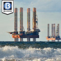 Picture of two offshore drilling operations from shoreline